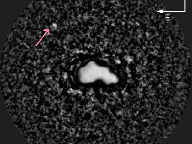 This telescope image shows asteroid Nysa as three-dimensional, bright body, with an arrow pointing at another object, Nysa's tiny moon, located a small distance away. 