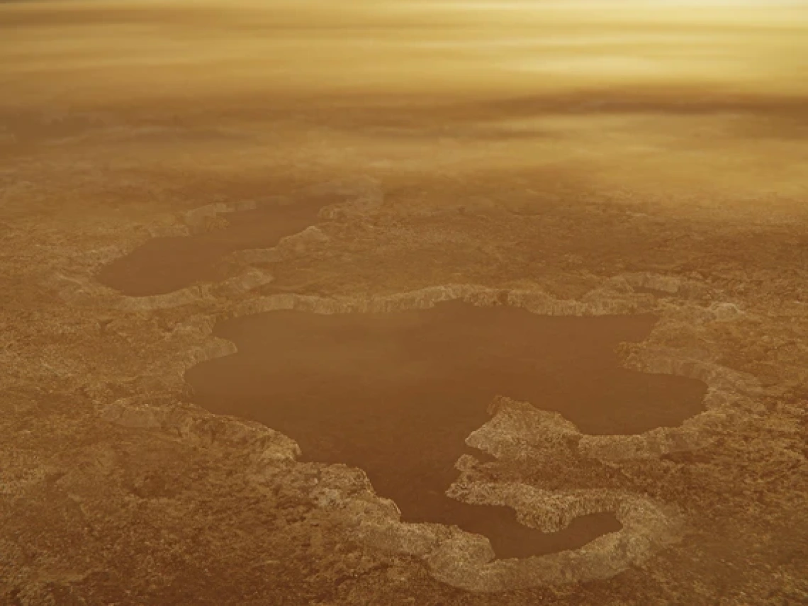This artist's concept illustrates a lake at the north pole of Saturn's moon Titan underneath a hazy, yellowish atmosphere.