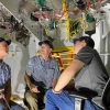 Buddy Martin (center) inspects components inside the support cell with Giant Magellan Telescope engineers Tomas Krasuski (left) and Colby Gottschalk (right).